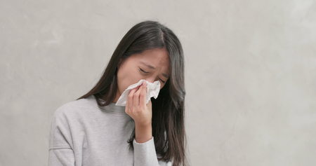 Woman sneezing and coughの写真素材
