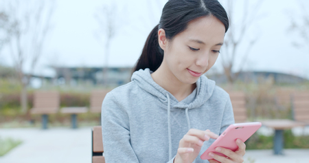 Woman using mobile phone outdoorの写真素材