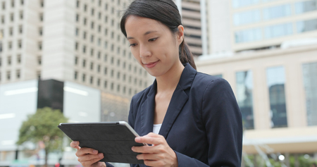Business woman using tablet at outdoorの写真素材
