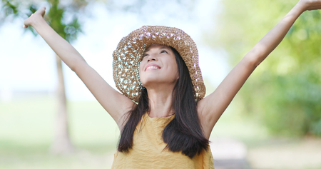 Woman open hand and take a deep breath at the parkの写真素材
