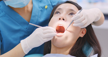 Doctor dentist working with patient in dental clinicの写真素材