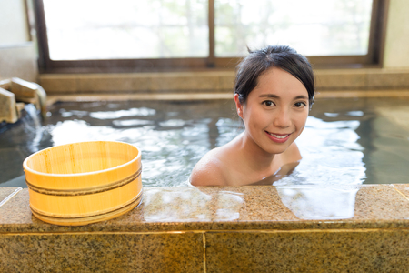 Woman taking bath in the japanese onsenの写真素材