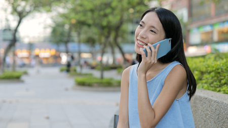 Woman talk to mobile phoneの写真素材