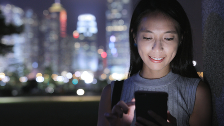 Woman working on smart phoneの写真素材