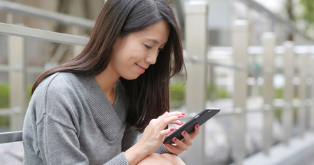 Young woman use of smart phone at outdoorの写真素材