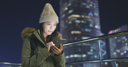 Woman use of mobile phone at outdoorの写真素材