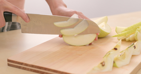 Cutting apple into piecesの写真素材