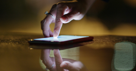Finger touch on cellphone at night