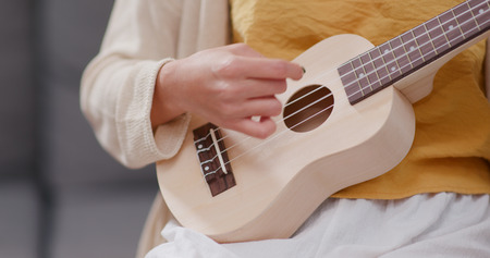 Woman practice ukulele