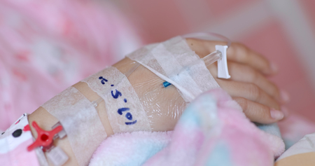 Woman get intravenous infusion in hospitalの写真素材