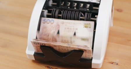 Money counting machine with Hong Kong dollarの写真素材
