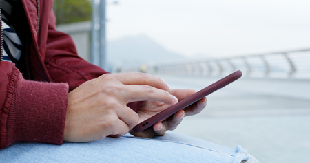 Close up of woman use of cellphone at outdoorの写真素材
