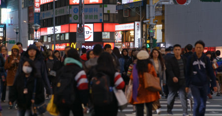 Taipei, Taiwan- 26 December 2018: People cross the road in Taipei city  at night