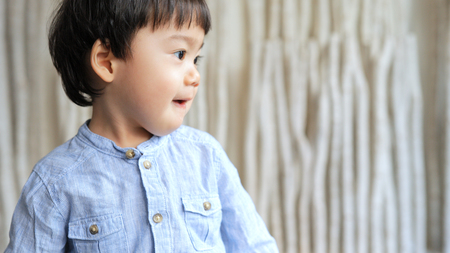 Little boy looking at the other sideの写真素材