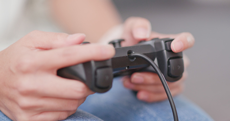 Woman playing video game at homeの写真素材