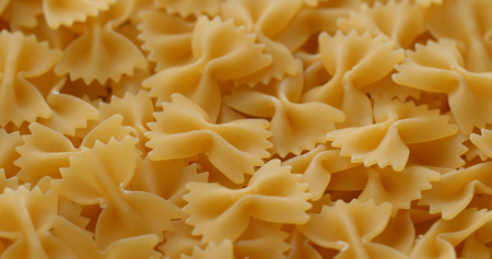 Stack of Dry uncooked farfalleの写真素材