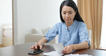 Woman use of mobile phone record the spending of daily lifeの写真素材