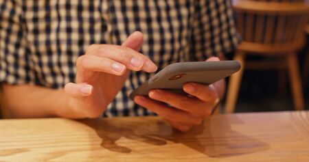 Close up of using mobile phone in restaurant