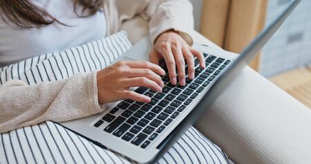 Woman works on computer at home