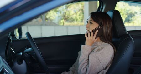 Woman talk to cellphone and drive a car