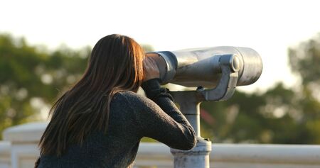 Travel woman look tough the binocular at outdoorの写真素材