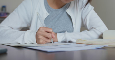 Woman study at home, write her essayの写真素材