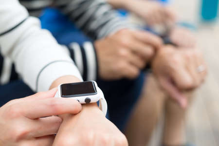 Group of people using smartwatch togetherの写真素材