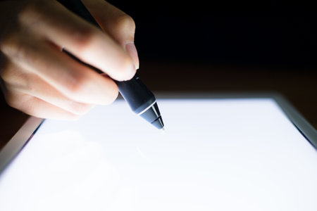 Woman using digital pen on tablet pcの写真素材
