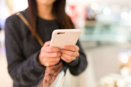 Woman using mobile phone for onlineの写真素材