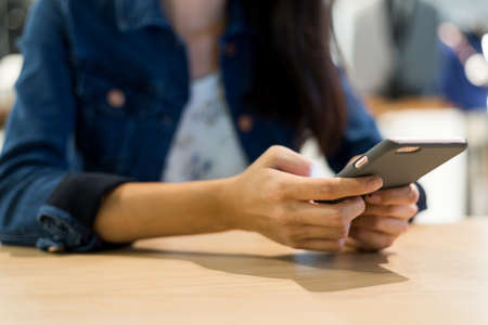 Use of mobile phone in cafeの写真素材