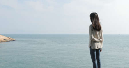 Young woman looking at the seaの写真素材