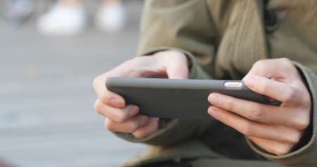 Woman play game on smart phoneの写真素材