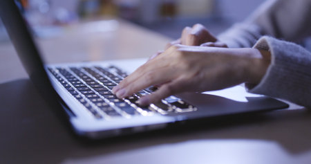 Woman use of notebook at home in the eveningの写真素材
