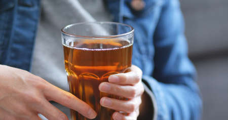Woman holding glass of teaの写真素材
