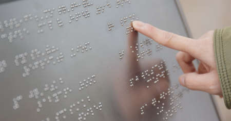 Blind reading on Braille at outdoor directoryの写真素材