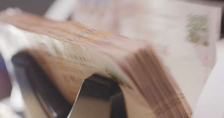 Cash counting machine counting Hong Kong dollarの写真素材