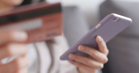 Shopping online with cellphone and credit cardの写真素材