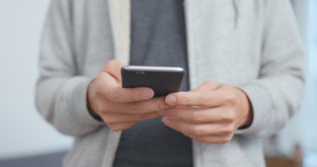 Man use of mobile phone close upの写真素材