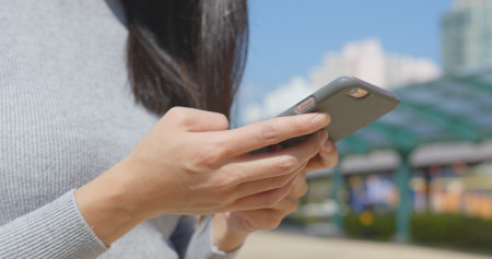 Using smart phone in the parkの写真素材