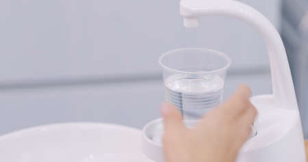 Patient rinsing mouth in dental clinicの写真素材