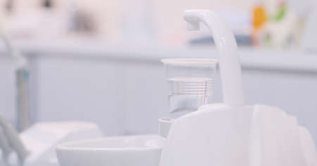 Patient rinsing mouth in dental clinicの写真素材