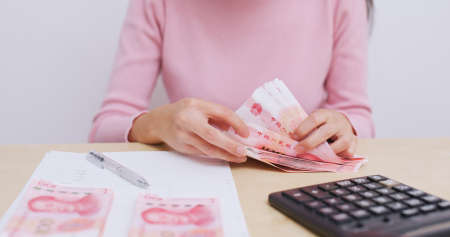 Housewife counting on expenditure at homeの写真素材