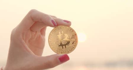 woman holding bitcoinの写真素材