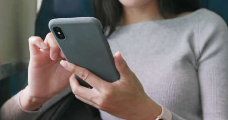 Woman use of smart phone on trainの写真素材
