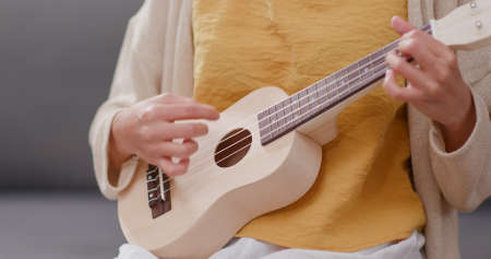 Woman playing song with ukuleleの写真素材