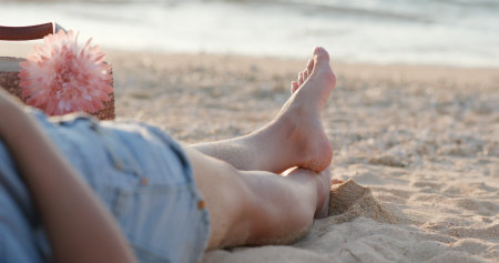 Woman lying on the beachの写真素材