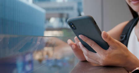Close up of woman use of smart phone in cityの写真素材