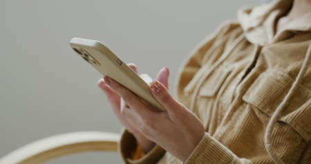 Woman use mobile phone at homeの写真素材