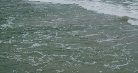 Sea wave splash on the beachの写真素材