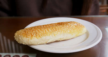 Woman eat bread in breakfast store at taiwanの写真素材